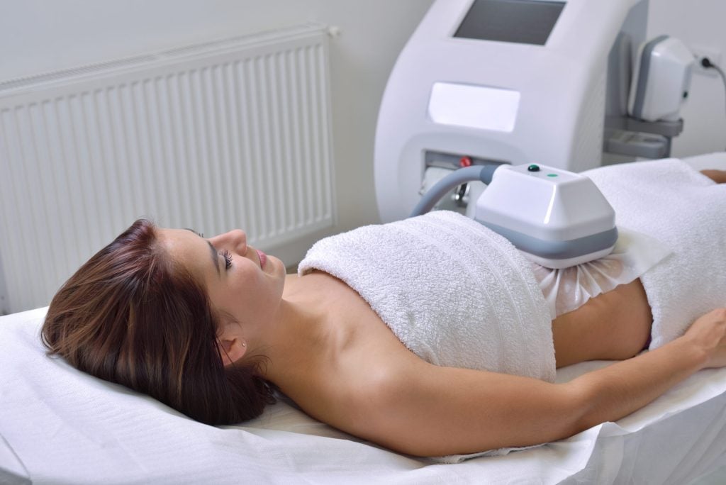 woman getting CoolSculpting treatment in cosmetic